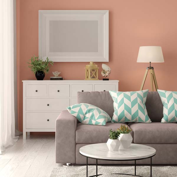 Modern living room showing a grey sofa and white sideboard.